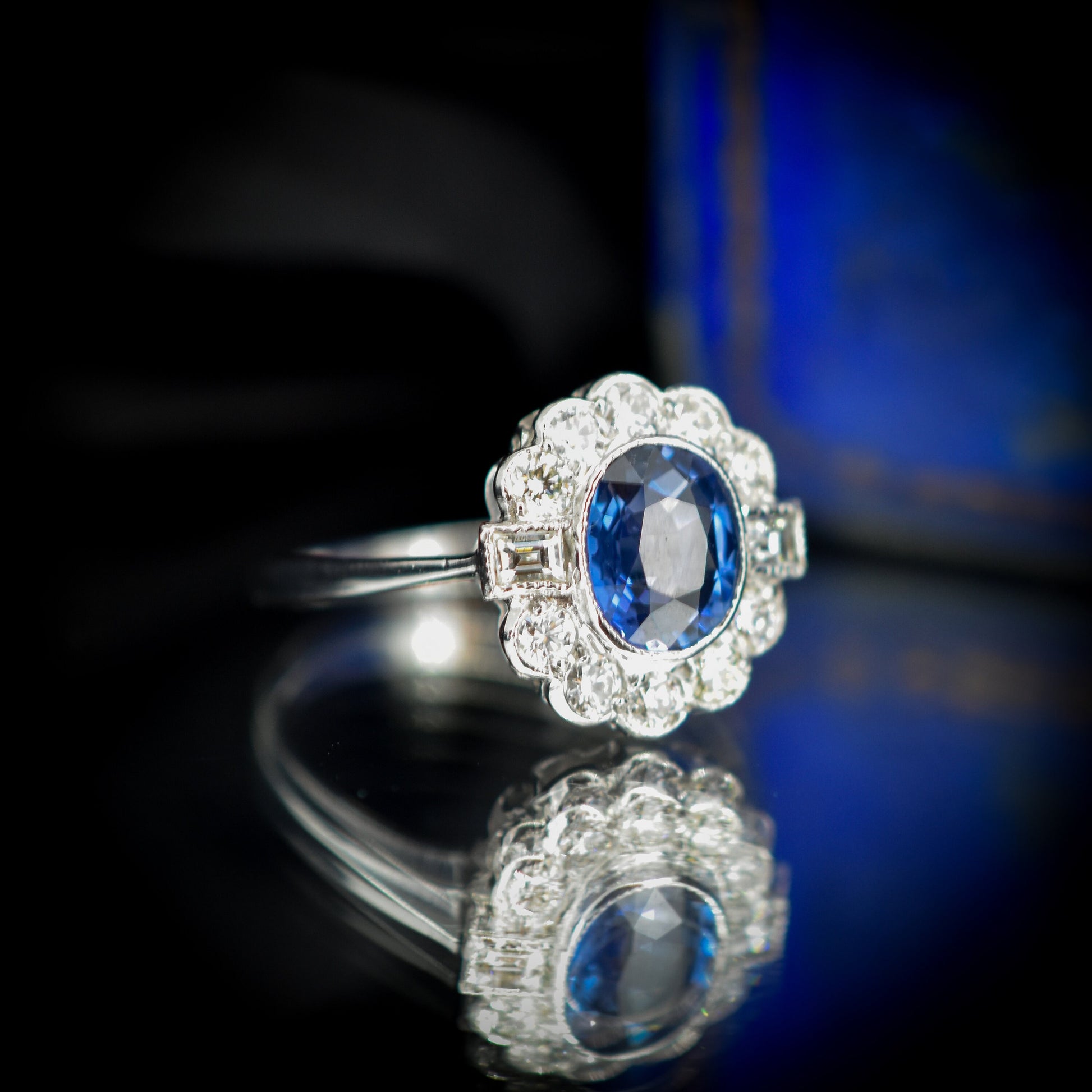 Oval Blue Sapphire and Diamond Bezel Halo Cluster Platinum Ring | Engagement